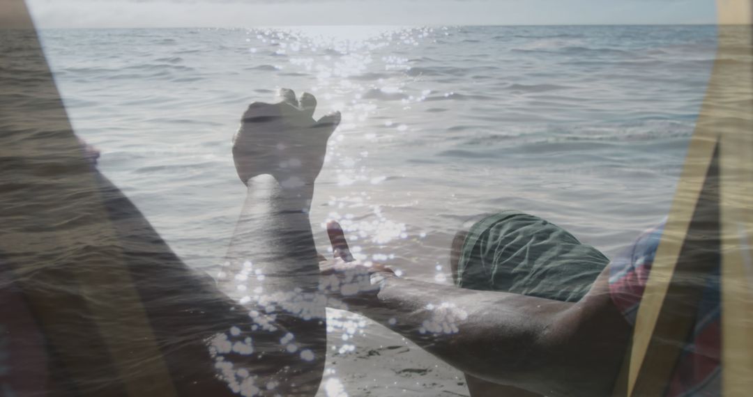 Senior Couple Hands Overlapping on Sunny Beach