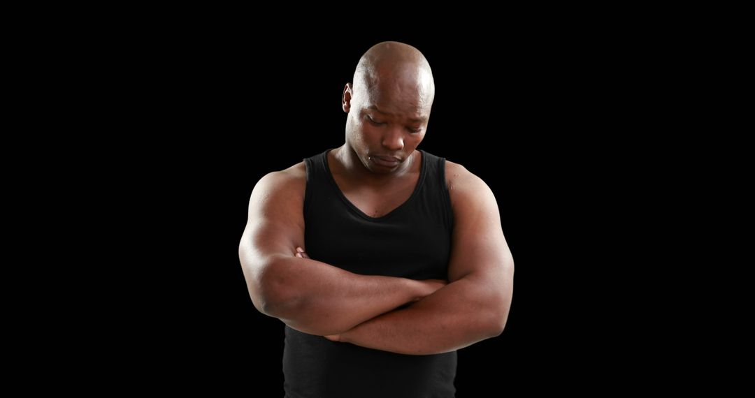 Pensive Man with Crossed Arms in Black Tank Top Against Black Background - Free Images, Stock Photos and Pictures on Pikwizard.com