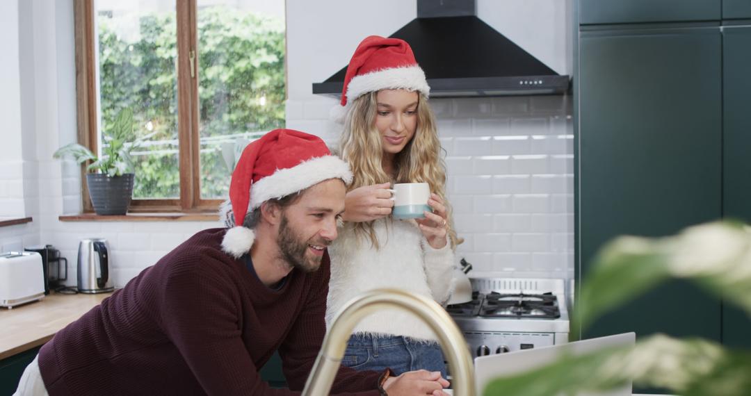 Couple Enjoying Coffee and Laptop in Christmas Decorated Kitchen - Free Images, Stock Photos and Pictures on Pikwizard.com