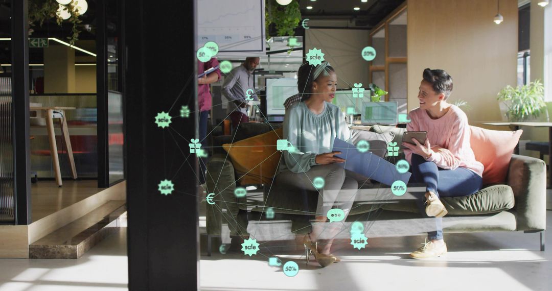 Two Women Collaborating with Digital Data Overlays in Modern Office Space