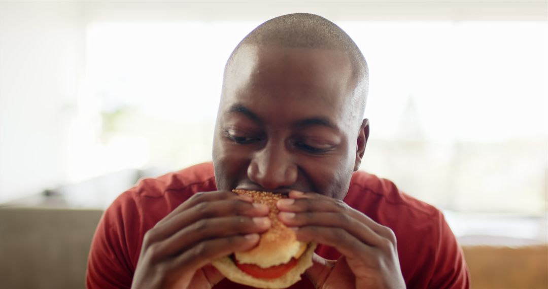 Man Enjoying Delicious Burger at Home