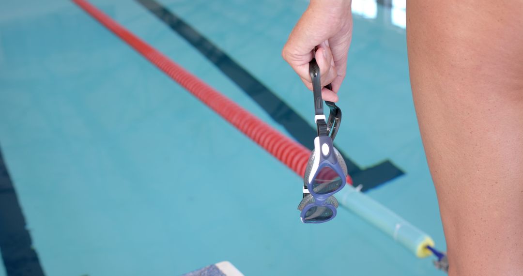 Swimmer Holding Goggles Ready for Pool Workout