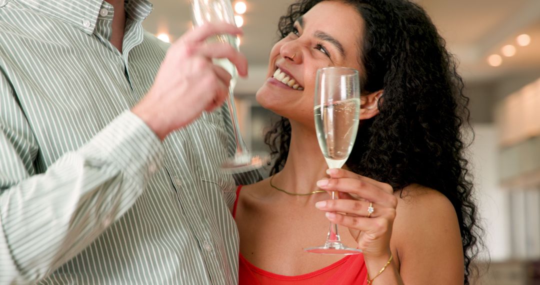 Joyful Couple Celebrating with Champagne in Living Room