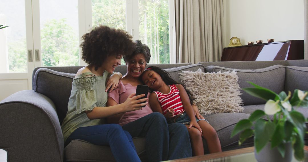 Three Generations of Women Enjoying Selfie on Couch - Free Images, Stock Photos and Pictures on Pikwizard.com