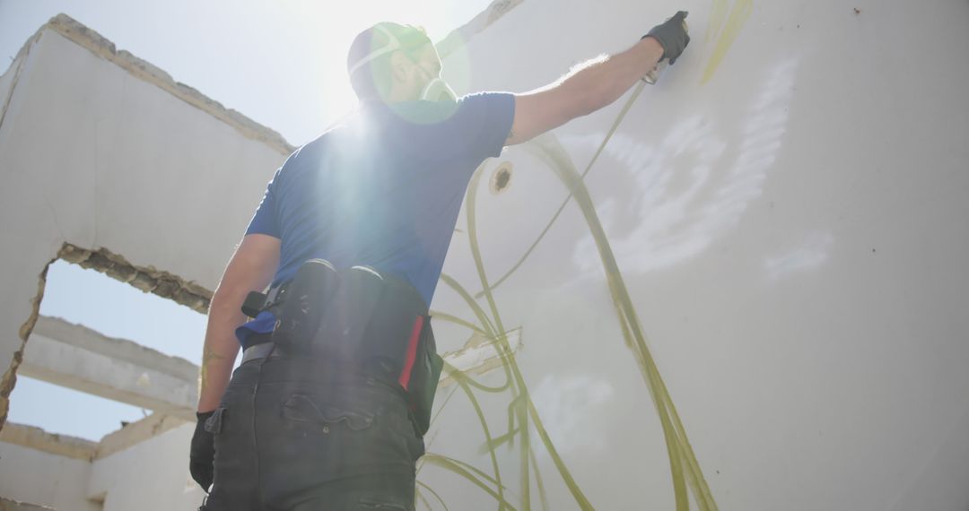 Construction Worker Painting Interior Wall Under Bright Sunlight - Free Images, Stock Photos and Pictures on Pikwizard.com