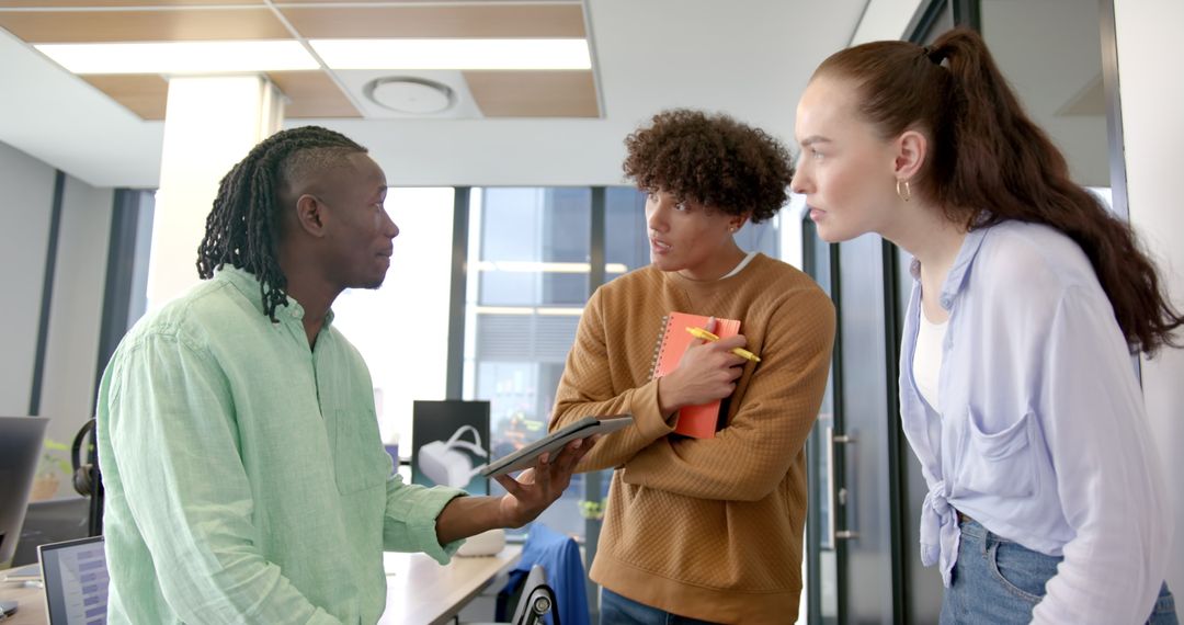 Teacher Discussing Project with Engaged Students in Classroom