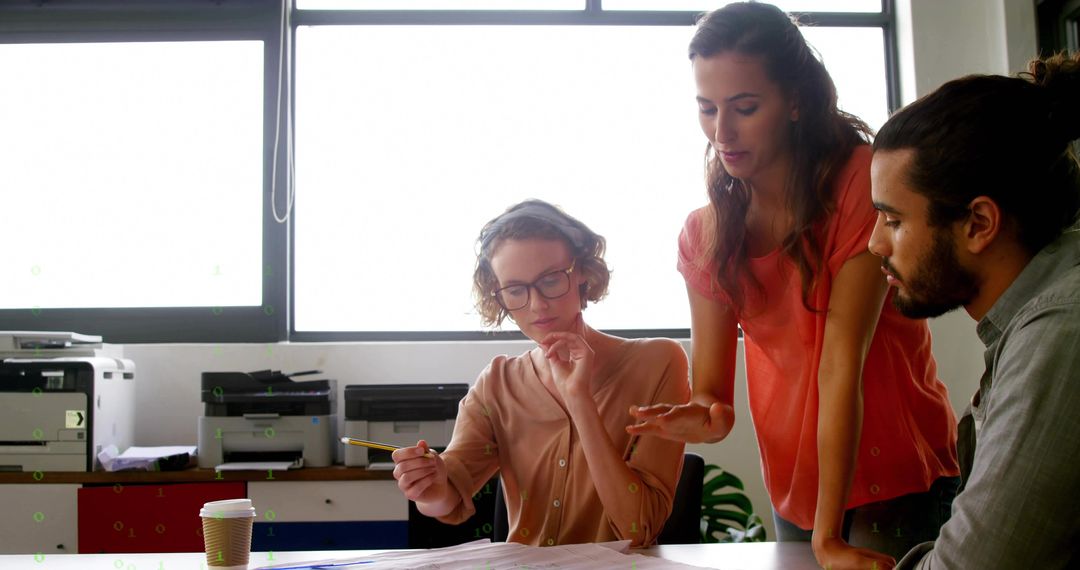 Three Colleagues Collaborating Over Documents in Bright Modern Office Workspace