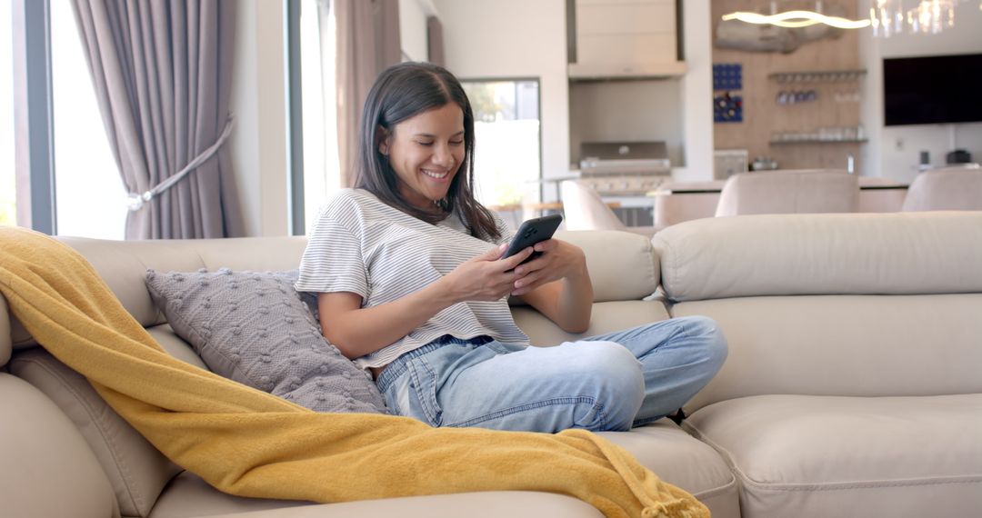 Teenage Girl Smiling and Relaxing at Home with Smartphone Technology