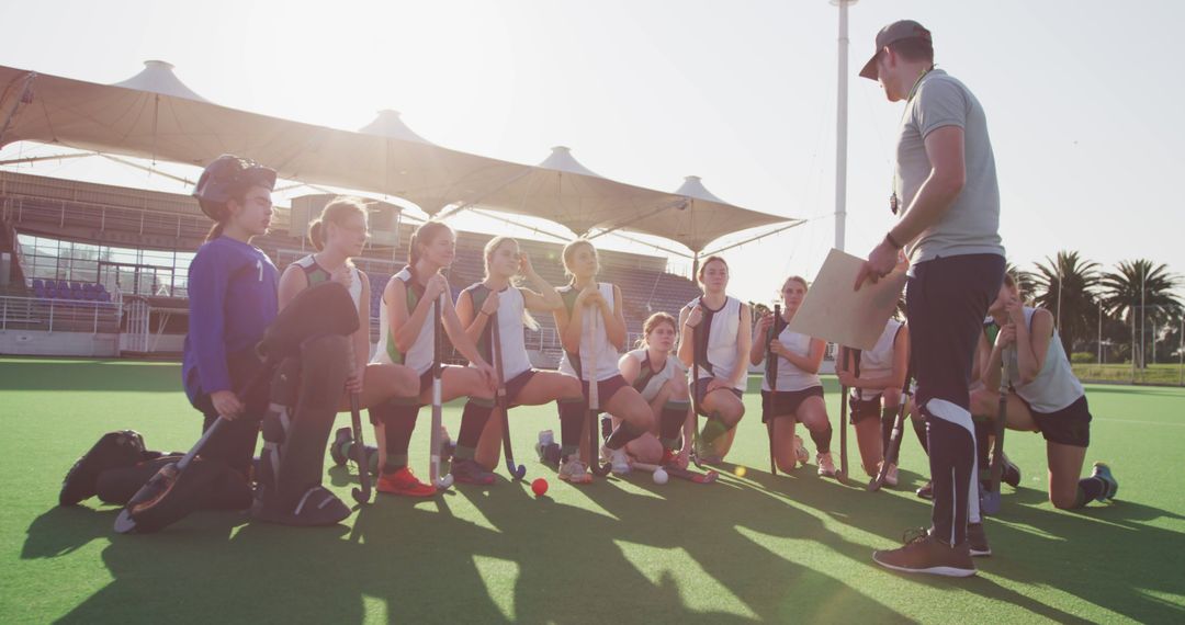 Female Field Hockey Team Receiving Instructions From Coach on Turf - Free Images, Stock Photos and Pictures on Pikwizard.com