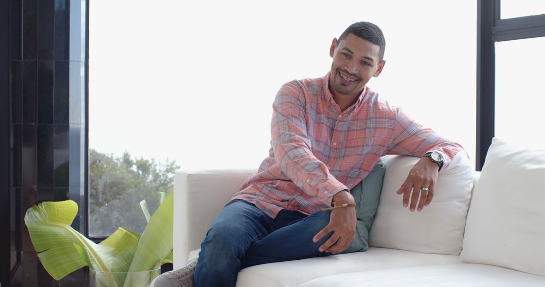 Man in Casual Relaxed Style Sitting on Sofa at Home