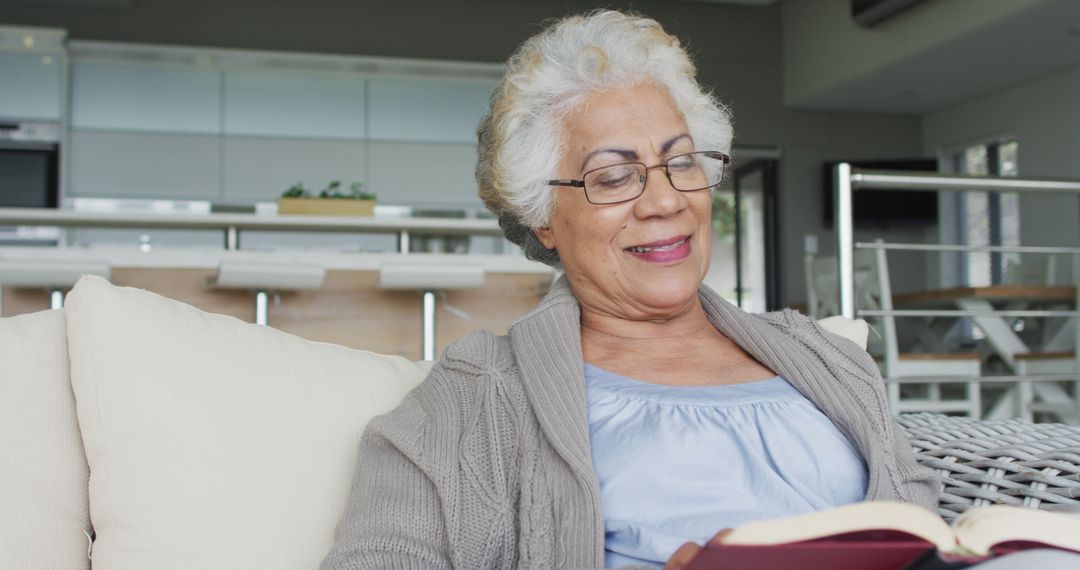 Elderly Woman Relaxing on Sofa and Reading a Book at Home - Free Images, Stock Photos and Pictures on Pikwizard.com