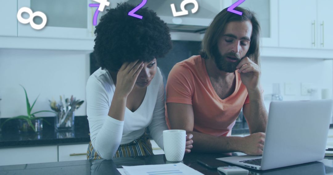 Couple Analyzing Financial Data with Laptop in Kitchen
