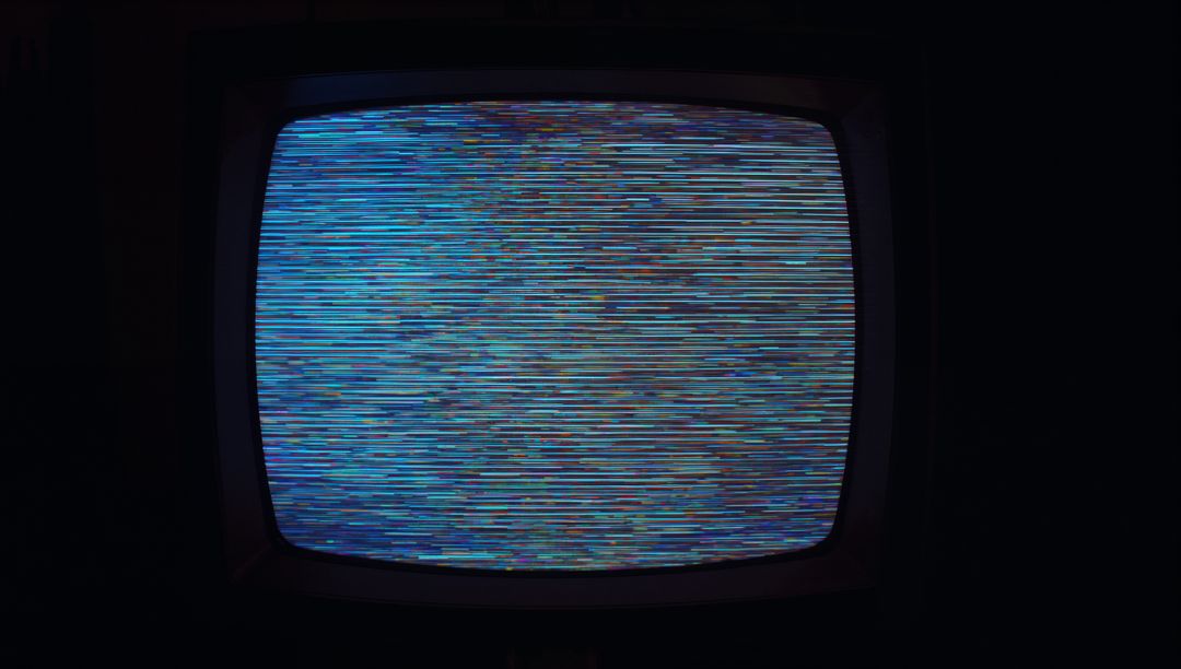 Vintage CRT Television With Retro Static Screen in Dimly Lit Room