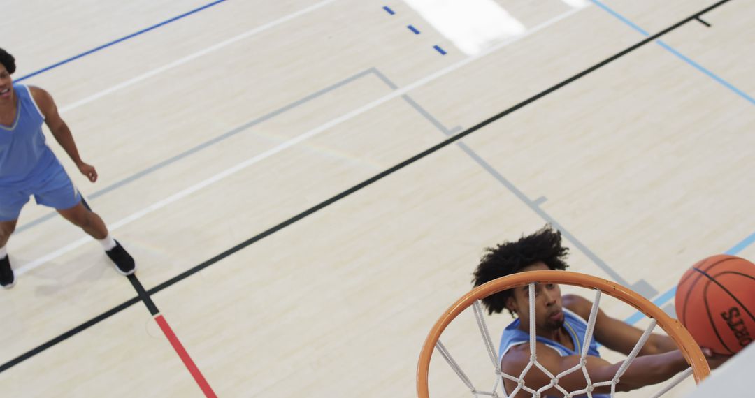 Basketball Player Dunking Ball in Indoor Court - Free Images, Stock Photos and Pictures on Pikwizard.com