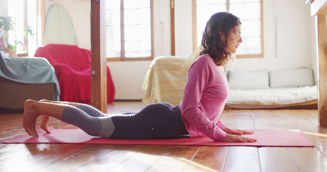 Woman Practicing Yoga Cobra Pose in Cozy Home Interior - Free Images, Stock Photos and Pictures on Pikwizard.com