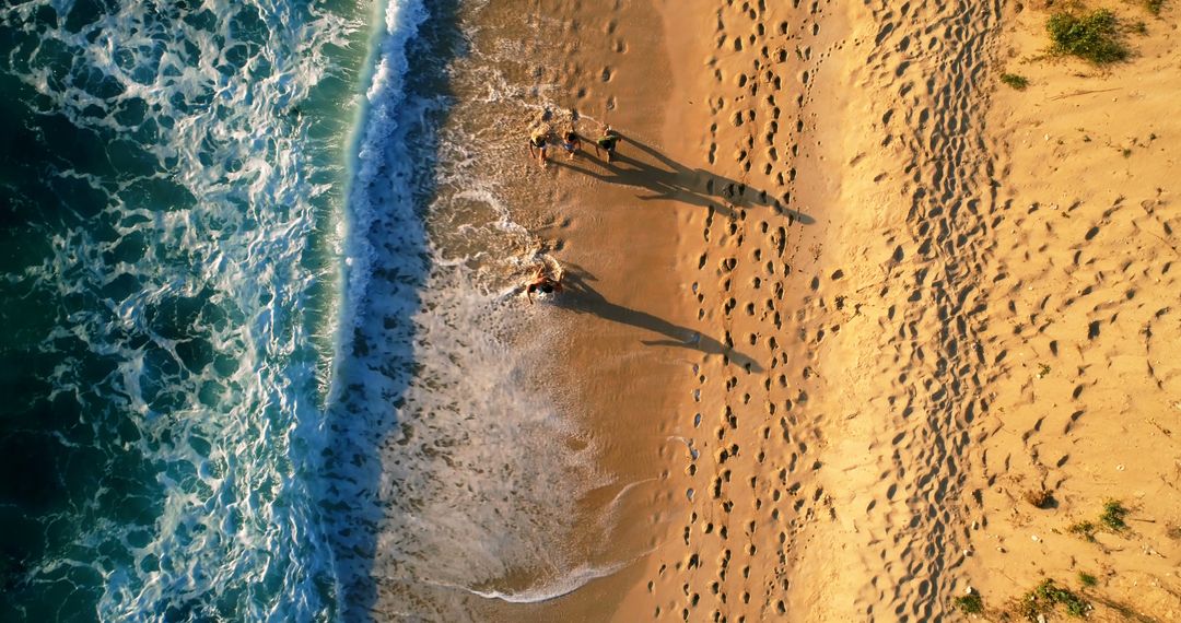 Aerial View of Beach with Ocean Waves and Footprints in Sand - Free Images, Stock Photos and Pictures on Pikwizard.com