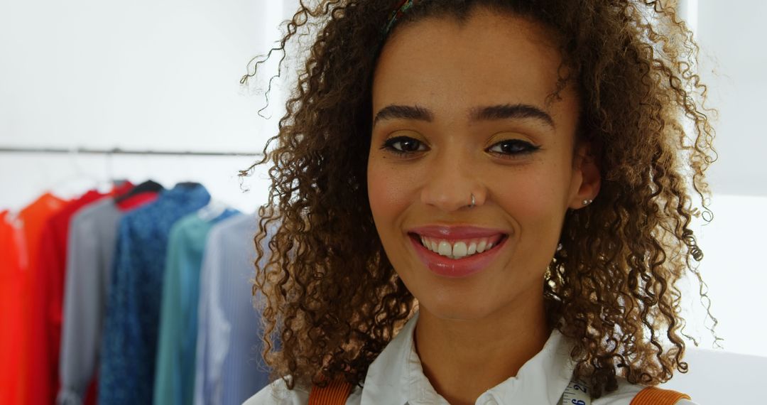 Smiling Fashion Designer Standing in Contemporary Workshop