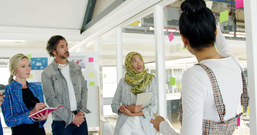 Creative Team Brainstorming with Colorful Notes in Modern Office