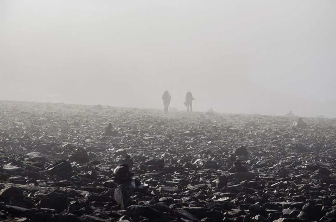 Hikers Walking in Foggy Rocky Landscape - Free Images, Stock Photos and Pictures on Pikwizard.com