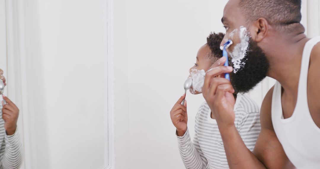 Happy African American Father and Son Shaving Beard Together in Bathroom - Free Images, Stock Photos and Pictures on Pikwizard.com