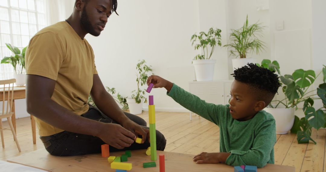 Father and Son Building Colorful Blocks in Bright Living Room - Free Images, Stock Photos and Pictures on Pikwizard.com