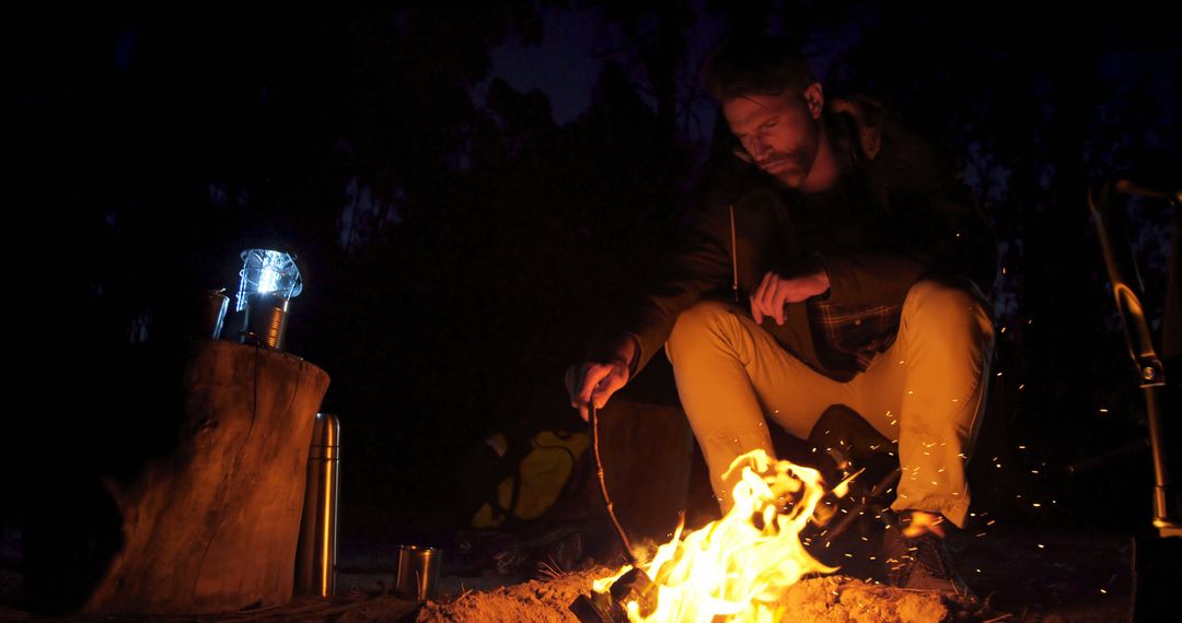 Man Enjoying Night Camping with Bonfire in Forest - Free Images, Stock Photos and Pictures on Pikwizard.com