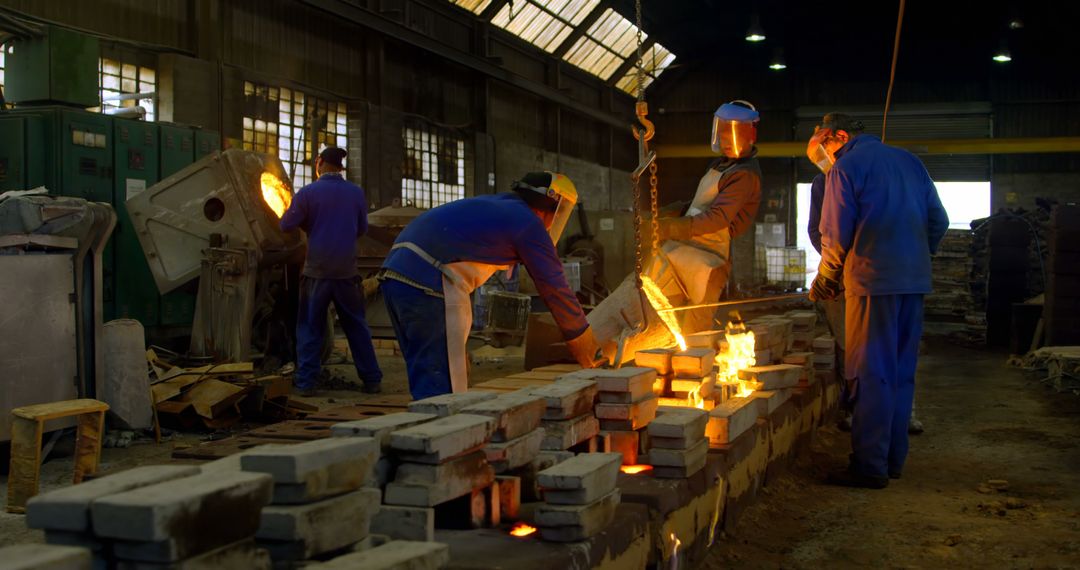 Workers in Foundry Pouring Molten Metal into Molds - Free Images, Stock Photos and Pictures on Pikwizard.com