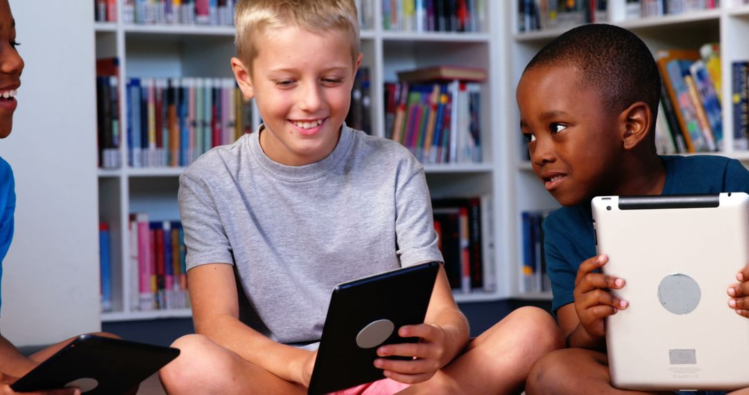 Happy Diverse Boys Using Tablets in School Library - Free Images, Stock Photos and Pictures on Pikwizard.com