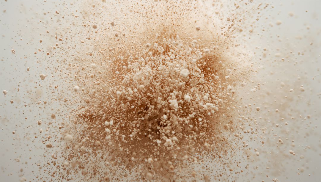 Dynamic Beige Powder Explosion Creating Abstract Shape