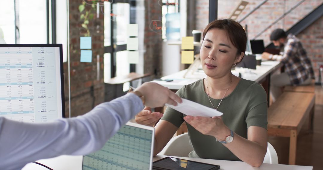 Team Reviewing Documents in Modern Office Environment