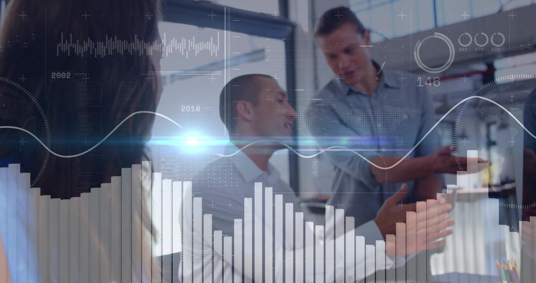Business team collaborating and analyzing data dashboards during modern office meeting