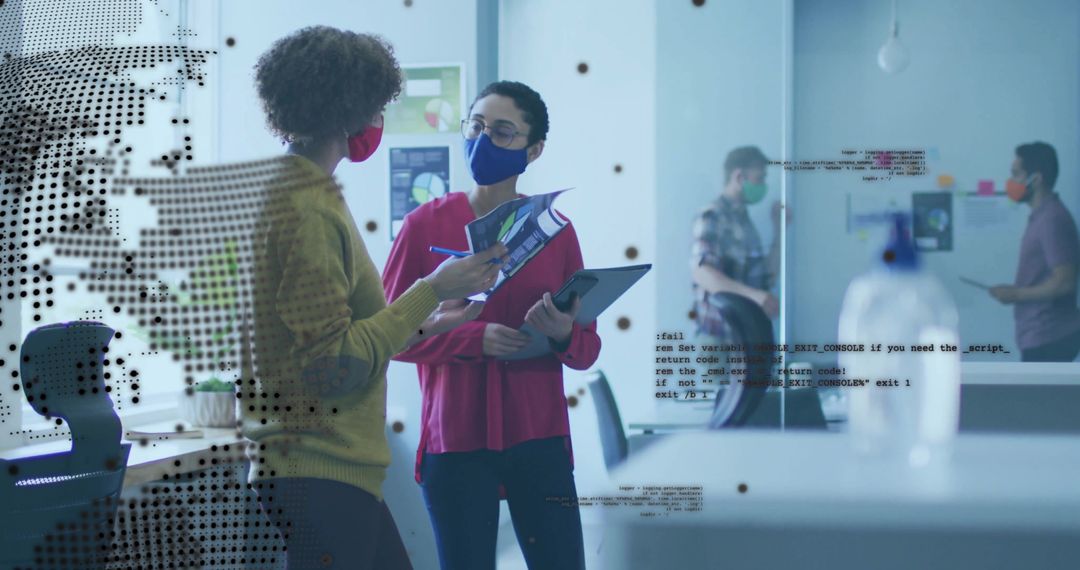 Masked Professionals Discussing Projects in Modern Office Setting