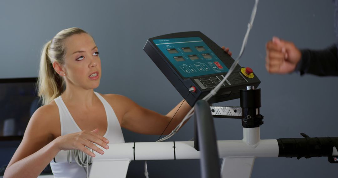 Woman Exercising on Treadmill in Gym with Trainer's Guidance - Free Images, Stock Photos and Pictures on Pikwizard.com