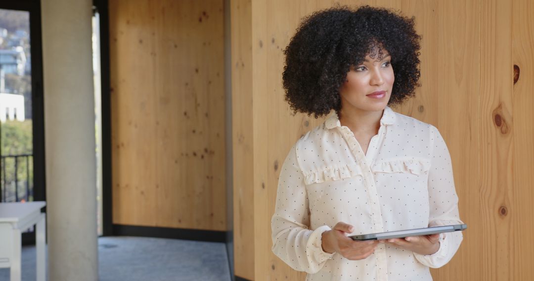Professional Woman Holding Tablet in Modern Minimalist Workspace