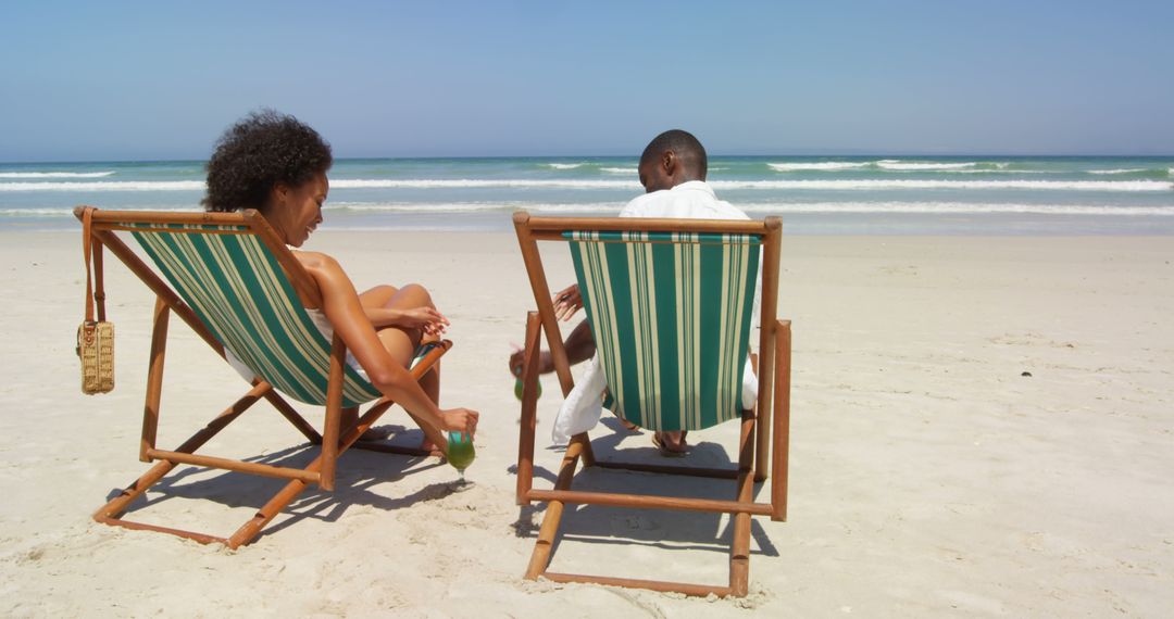 Couple Relaxing on Beach Chairs by Sea - Free Images, Stock Photos and Pictures on Pikwizard.com