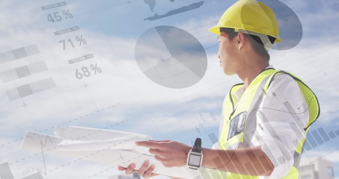 Asian Architect Analyzing Building Plans over Economic Graphs