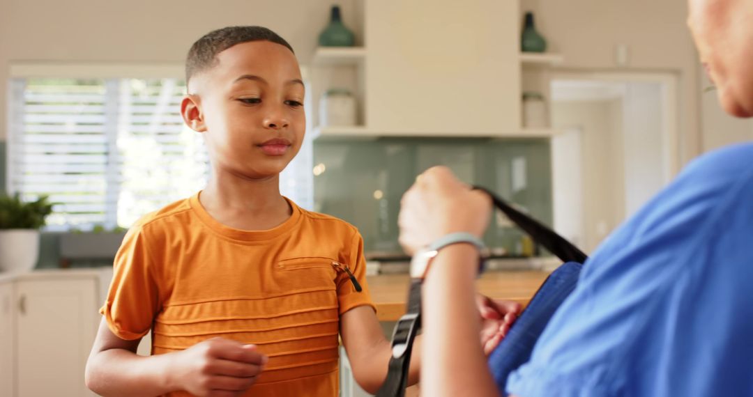 Mother and Son Connecting in Modern Kitchen with Backpack
