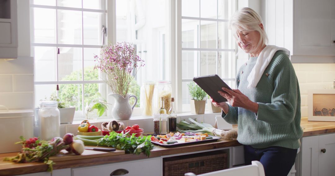 Senior Woman Using Tablet for Healthy Recipes in Home Kitchen - Free Images, Stock Photos and Pictures on Pikwizard.com