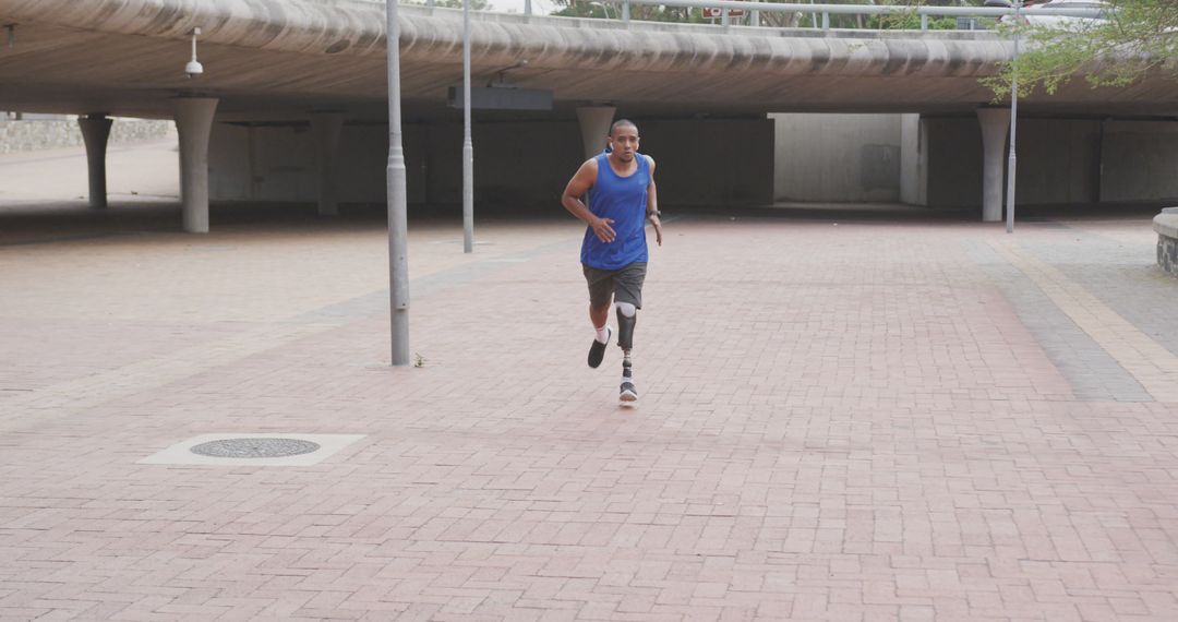 Determined Young Man with Prosthetic Leg Running Outdoors - Free Images, Stock Photos and Pictures on Pikwizard.com