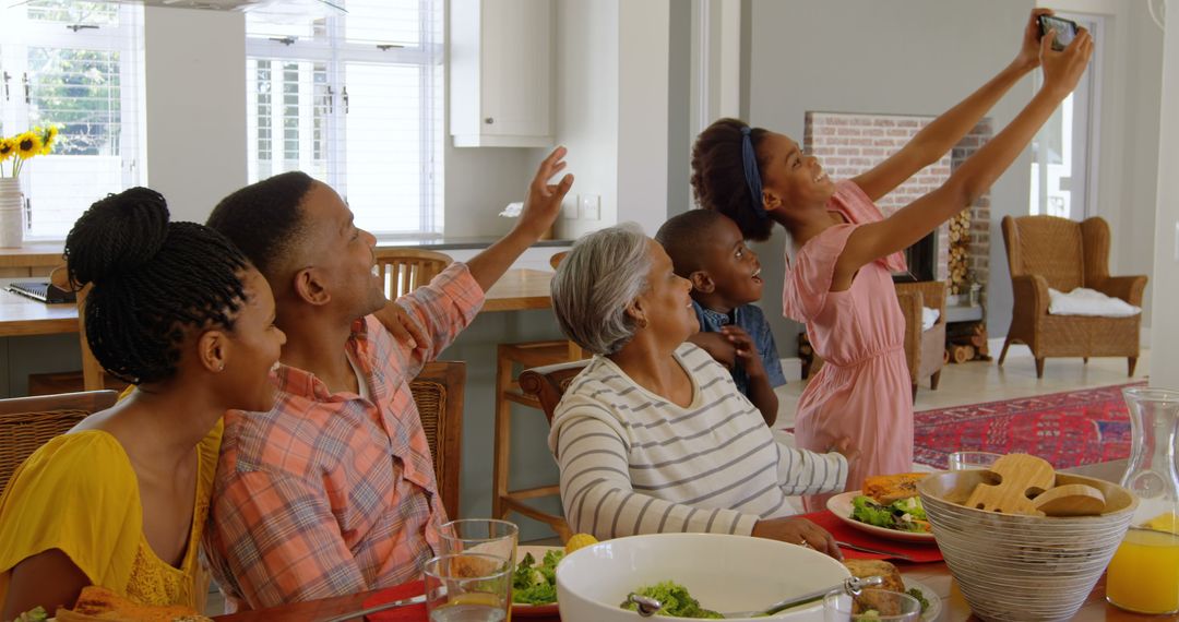 Joyful Multigenerational African American Family Taking Selfie at Dinner Table - Free Images, Stock Photos and Pictures on Pikwizard.com