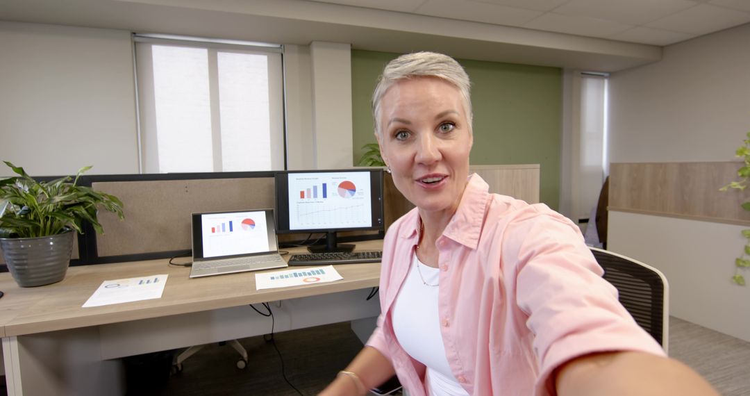 Professional Businesswoman Analyzing Data Charts in Modern Office