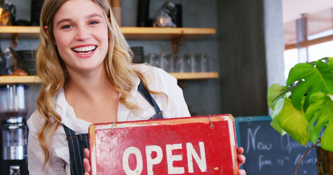 Smiling Barista Holding Open Sign Inside Coffee Shop - Free Images, Stock Photos and Pictures on Pikwizard.com