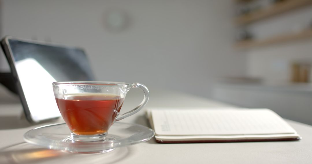 Tranquil Workspace with Tea and Open Notebook