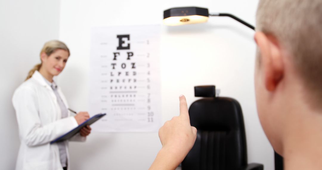 Child Pointing During Eye Test with Optometrist in Clinic - Free Images, Stock Photos and Pictures on Pikwizard.com