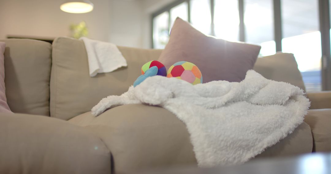 Cozy Beige Sofa with Plush Blanket and Colorful Cushions