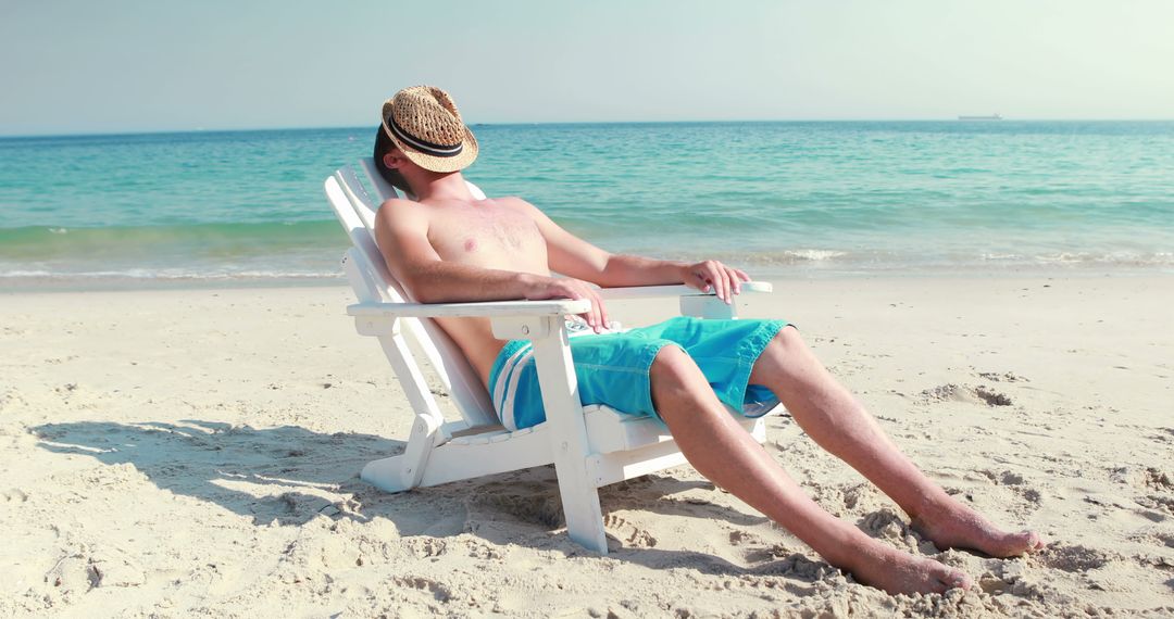 Man Relaxing on Beach Chair by Ocean - Free Images, Stock Photos and Pictures on Pikwizard.com