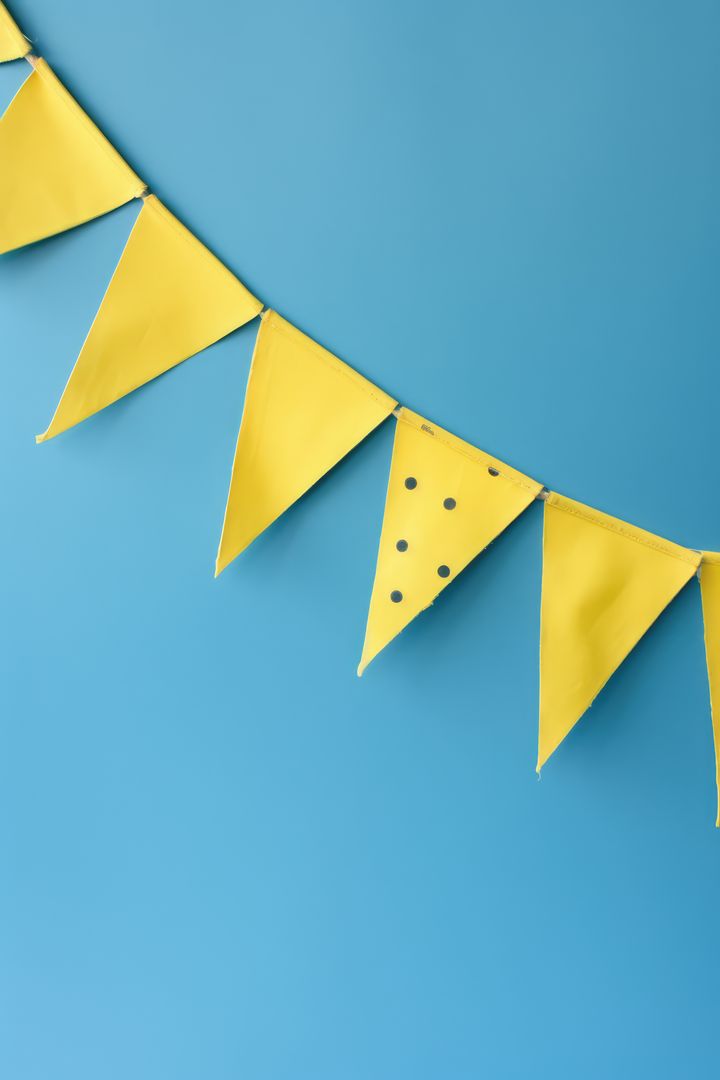 Yellow Decorative Bunting Flags on Blue Background - Free Images, Stock Photos and Pictures on Pikwizard.com