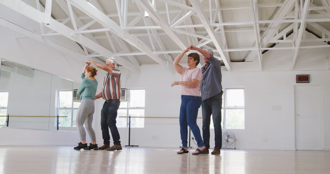 Active seniors practicing dance moves in bright studio - Free Images, Stock Photos and Pictures on Pikwizard.com