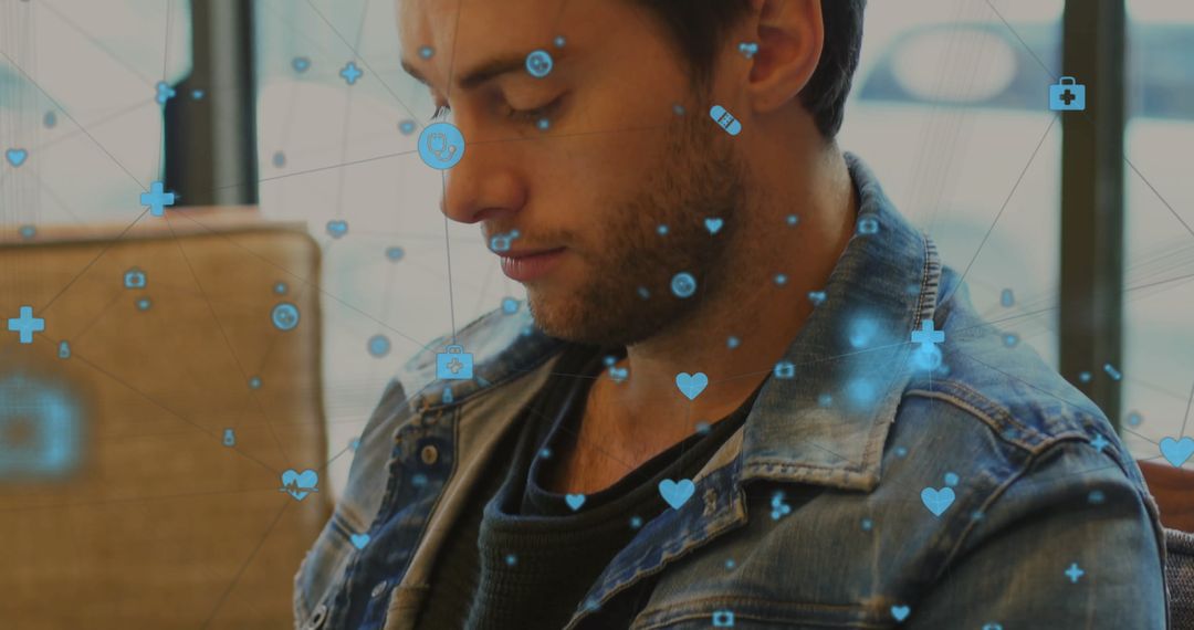 Contemplative Man with Digital Medical Icons in Modern Setting