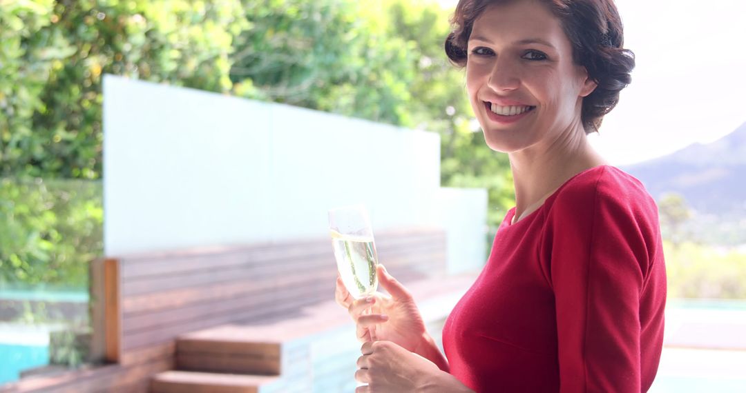 Woman holding glass of champagne  - Free Images, Stock Photos and Pictures on Pikwizard.com
